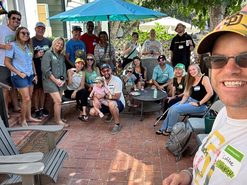 Neighbors gathered with coffee on a brick patio at the Mission Beach Neighbor Hang